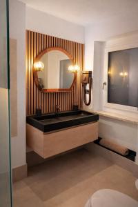 a bathroom with a sink and a mirror at Bellavista in Coazze