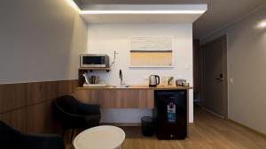 a room with a desk with a microwave and a table at La Carolina Suite Moderna - Excelente Ubicación in Quito