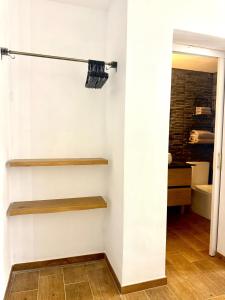a room with white walls and wooden shelves at Candela 2 en candelaria in Candelaria