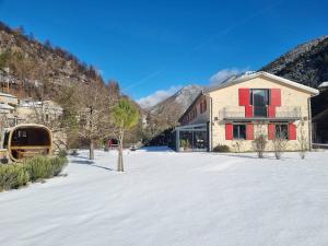 a building in the snow next to a mountain at La Bergerie à Menée in Châtillon-en-Diois