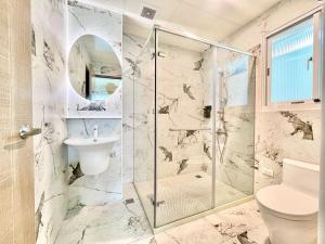 a bathroom with a shower and a toilet and a sink at Bird Walking in Yuli +40 photos
