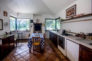 a kitchen with a table with a table cloth on it at La Casa Degli Elfi in Manziana