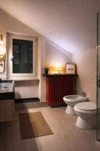 a bathroom with a toilet and a red radiator at Bellavista in Coazze