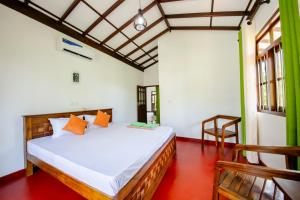 a bedroom with a bed in a room at Kataliya Villa in Ahungalla