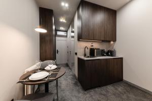 a small kitchen with a table and a counter at EVURI Apartments BUDAPEST 2 in Uzhhorod