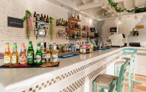 a bar with bottles of alcohol on the counter at Hotel Panorama in Koukounaries