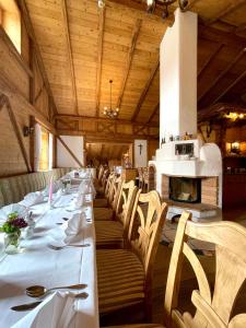 a dining room with tables and chairs and a fireplace at Gasthof & Hotel Jägerwirt in Aufhofen