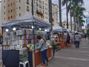 a woman standing at a book stand on a city street at The Layover Condotel ,Palm Tree two Villas ,cluster 2 - unit 7q , New Port Boulevard , Newport City ,NAIA Terminal 3 , Pasay City , Philippines in Sampong