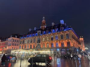 a large building with lights on it at night at Studio Mookaite in Lille