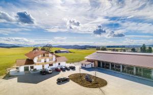 an aerial view of a house with cars parked in a driveway at Gasthof & Hotel Jägerwirt in Aufhofen
