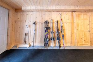 a room with a bunch of skis hanging on a wall at Spa Outdoor & Adventure - LEnigmasud in Saint-Philémon +55 photos