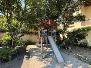 a playground with a slide and a play structure at Espaço Ybirá in Marechal Deodoro