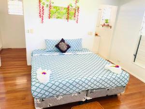 a bedroom with a bed with two baskets on it at The Ideal Bed & Breakfast in Nadi