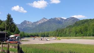 a group of airplanes parked in a parking lot with mountains at Ruhlander-Hof in Unterwössen