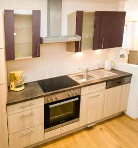 a kitchen with a sink and a stove at Ruhlander-Hof in Unterwössen +5 photos