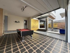 a pool table on a patio with a ping pong ball at Pool Villa Pattaya 5BD - Exquisite Pool Villa G in Nong Prue