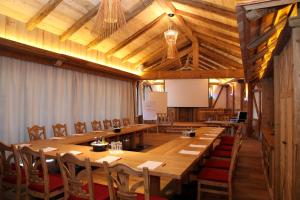 a large conference room with wooden tables and chairs at Gasthof & Hotel Jägerwirt in Aufhofen