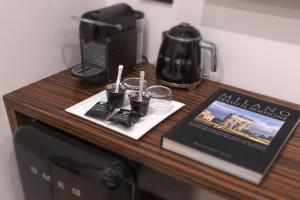 a wooden table with glasses on top of a microwave at The Place in Milan