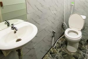 a bathroom with a sink and a toilet at Spekta Merbabu powered by Cocotel in Jlarem +24 photos