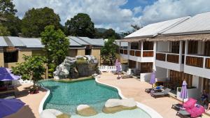 an image of a hotel with a pool and a waterfall at White Sand Samui Resort in Lamai