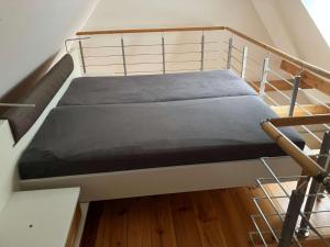 a bunk bed in a room with a staircase at Ferienwohnung Achelpöhler in Hagen im Bremischen +6 photos
