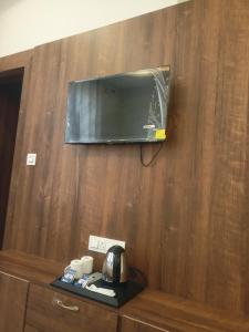a tv hanging on a wall in a hotel room at Hotel Pushkar Town in Pushkar