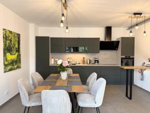 a kitchen and dining room with a table and chairs at Ferienwohnung-Karwe in Karwe