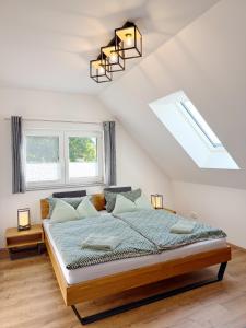 a bedroom with a large bed in a attic at Ferienwohnung-Karwe in Karwe