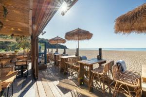 a restaurant on the beach with tables and chairs at Hawke in Dartmouth