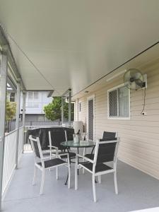 a table and chairs sitting on a patio at Bongaree Beach Shack - close to the bridge! in Bongaree