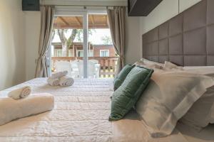 a bedroom with a large bed with towels on it at Club del Sole Spina Family Collection in Lido di Spina +146 photos