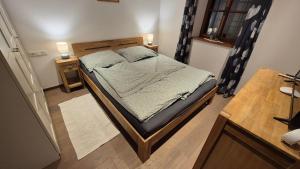 a bed in a room with two lamps on two tables at Ferienwohnung beim Schnellerbauer in Micheldorf in Oberösterreich +5 photos