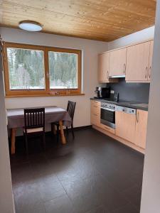 a kitchen with a table and a table and chairs at AusZeit in Gschnitz