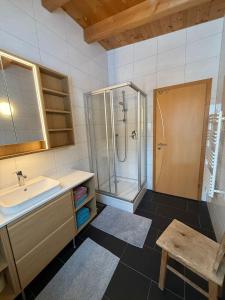 a bathroom with a sink and a shower at AusZeit in Gschnitz +16 photos