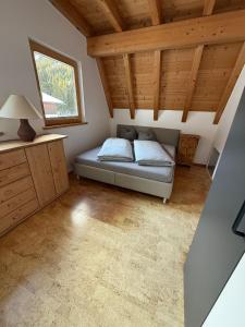 a bedroom with a bed in a room with wooden ceilings at AusZeit in Gschnitz