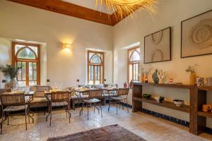 a dining room with a table and chairs at Bab Akoul Palmeraie - Boutique Hotel & Spa in Marrakesh