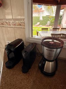 a blender and a toaster on a counter next to a window at Casalapraia in Caraguatatuba