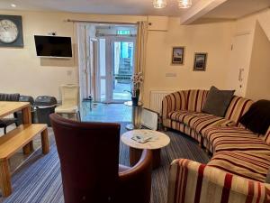 a living room with a couch and a table at Marine Apartment in Aberystwyth