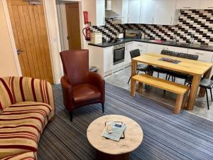 a living room with a couch and a table at Marine Apartment in Aberystwyth