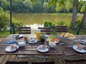 a picnic table with food and a view of a lake at Brauhaus am See in Oberthulba