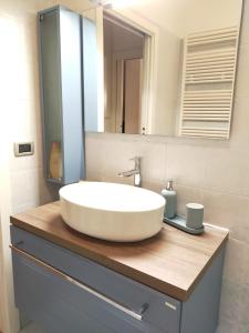 a bathroom with a sink and a mirror at Appartamento Le Nuvole da Davide e Romina in Santarcangelo di Romagna +37 photos
