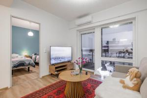 a living room with a teddy bear sitting on a couch at Lapland Apartment in Rovaniemi