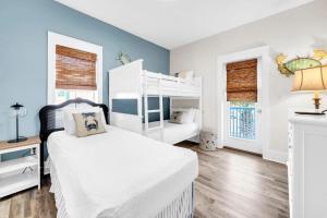 a bedroom with a white bed and a bunk bed at Blue Sky Bungalow 156 in Seagrove Beach