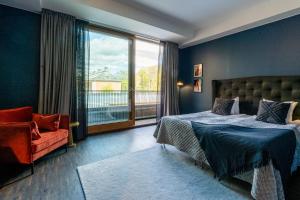 a bedroom with a bed and a chair and a window at Backstage Hotel Stockholm in Stockholm +124 photos