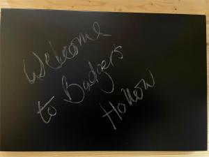 a chalkboard sign with the words welcome to your town at Badgers Hollow by Tiny Away in Whitchurch