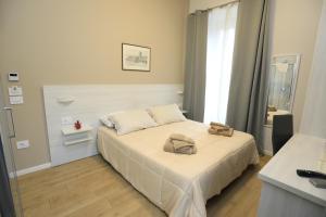 a bedroom with a bed with two bags on it at B&B Costa degli Dei in Tropea