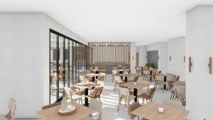 a restaurant with tables and chairs and windows at Stemma Hotel in Sidari