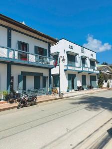 a motorcycle parked in front of a building at Nagara Premium River View in Luang Prabang