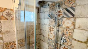 a shower with a glass door in a bathroom at Casa CarMa - Relax & Comfort a Cala Gonone in Cala Gonone