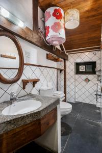 a bathroom with a sink and a toilet and a mirror at Rokeby Manor in Mussoorie +29 photos
